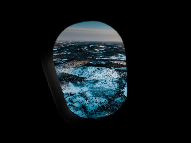 A serene landscape view through a clean window at sunrise.